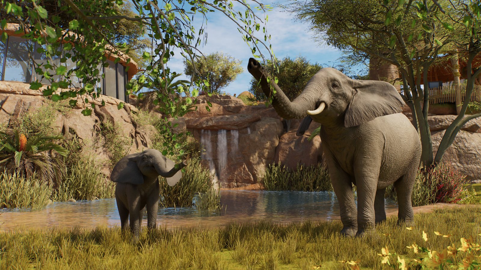 Elephant and calf reaching for branches beside a waterfall